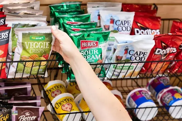 Hand reaching for bag of chips